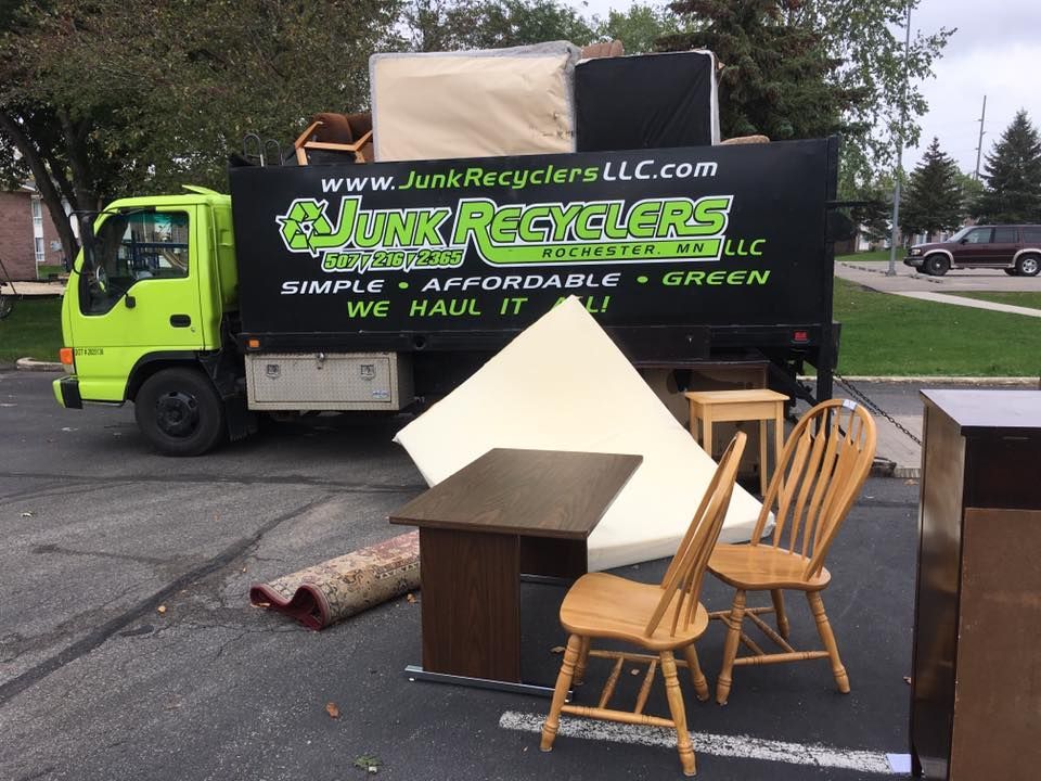 A green truck with furniture outside