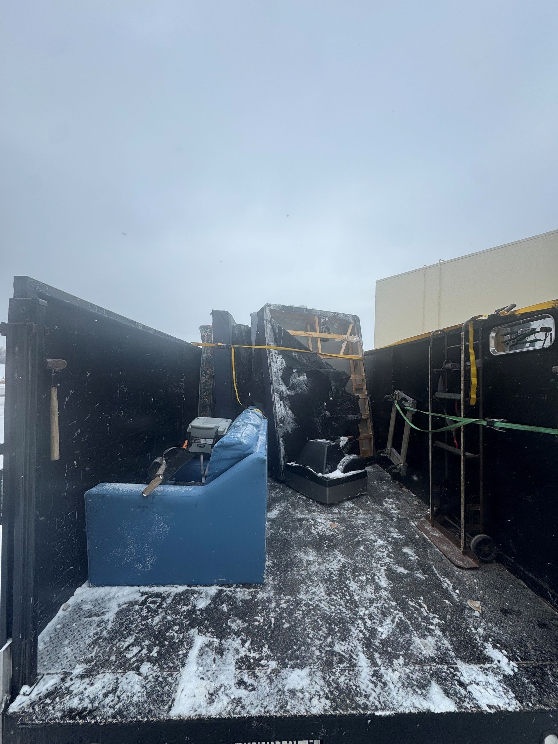 Professional moving worker carrying items, representing reliable furniture removal during daytime.