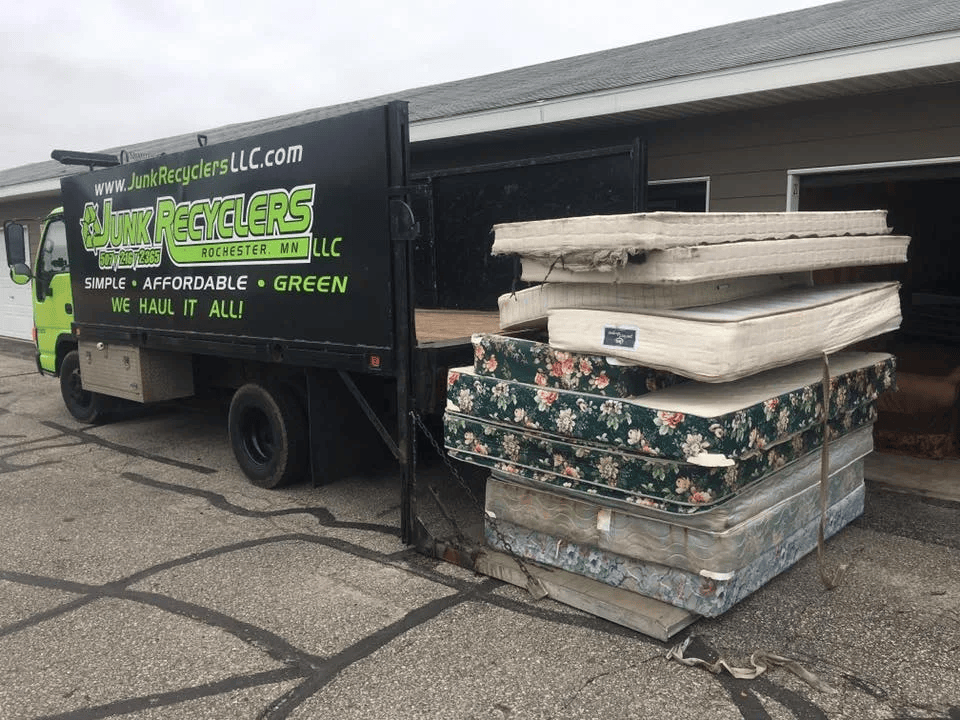 Professional moving worker carrying items, representing reliable furniture removal during daytime.