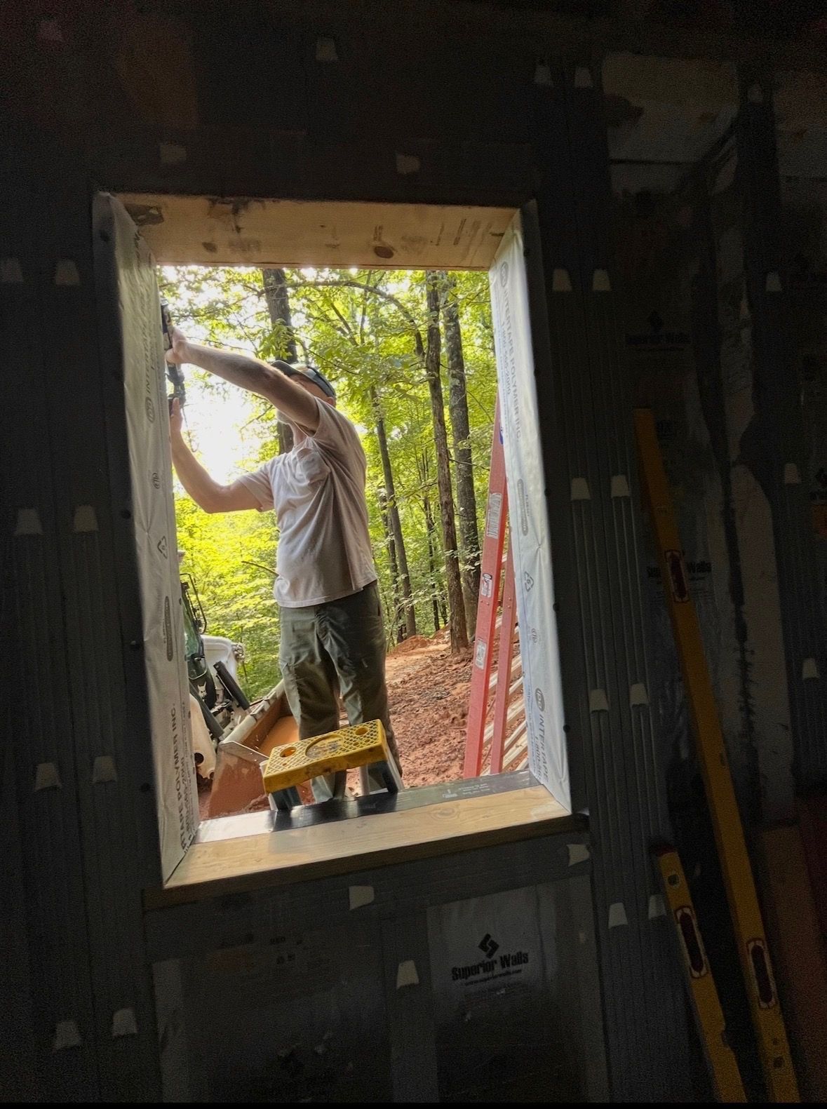 A man is working on the ceiling of a house.