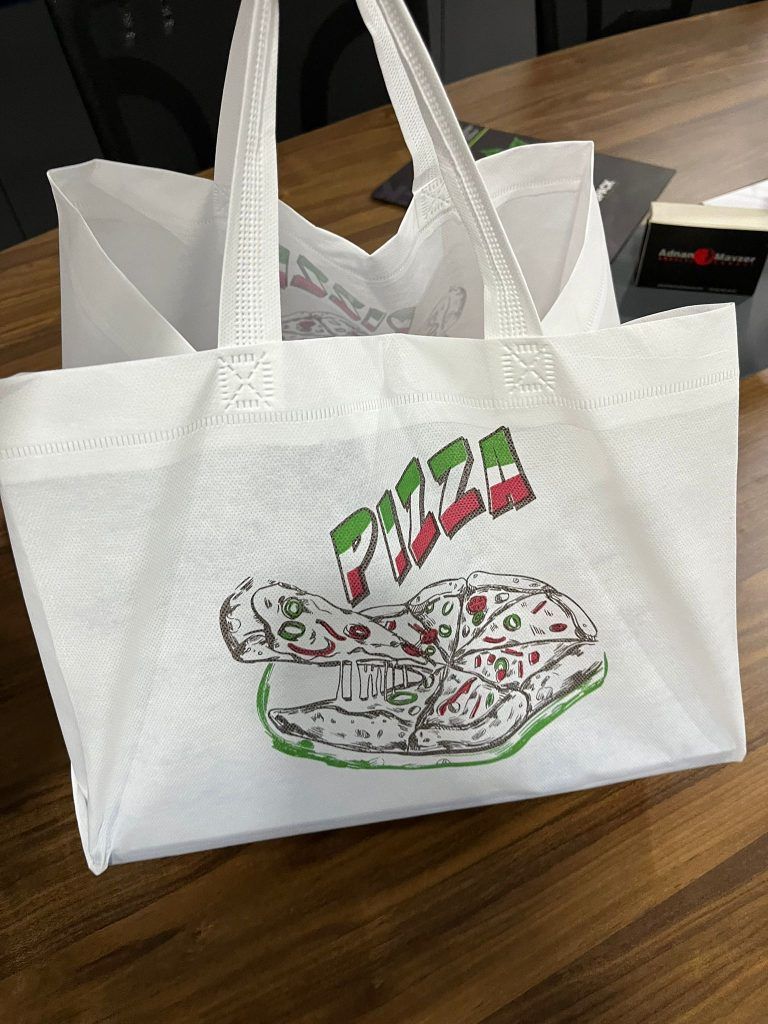 Two clear plastic cups with "ENVIRONPAC" logo, stacked on a gray background.