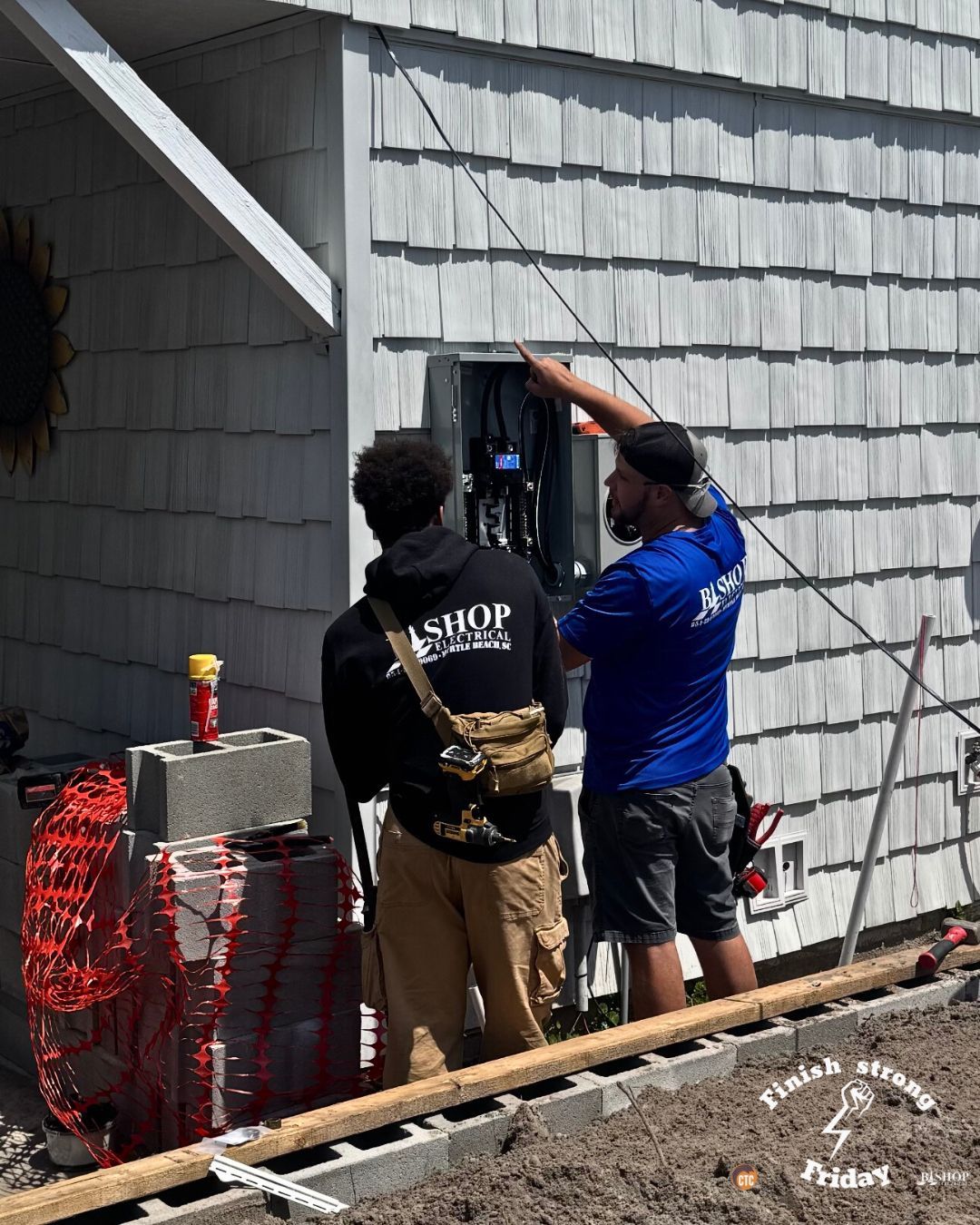 Two CTC electricians installing an electrical panel