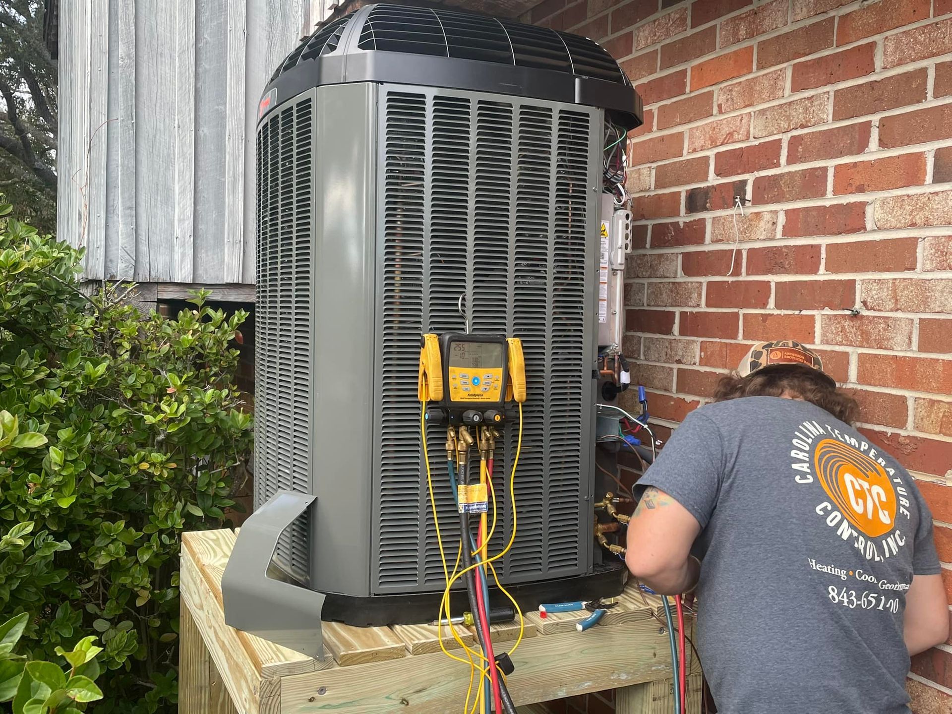 Carolina Temperature Control HVAC technician repairing an outdoor unit