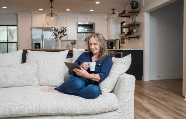 Woman sitting on couch enjoying air conditioning