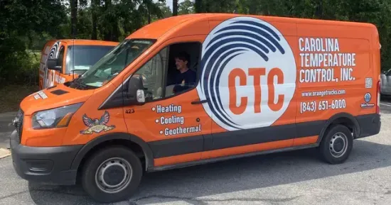 CTC orange truck Orange service truck that has the words heating, cooling, and geothermal on it.