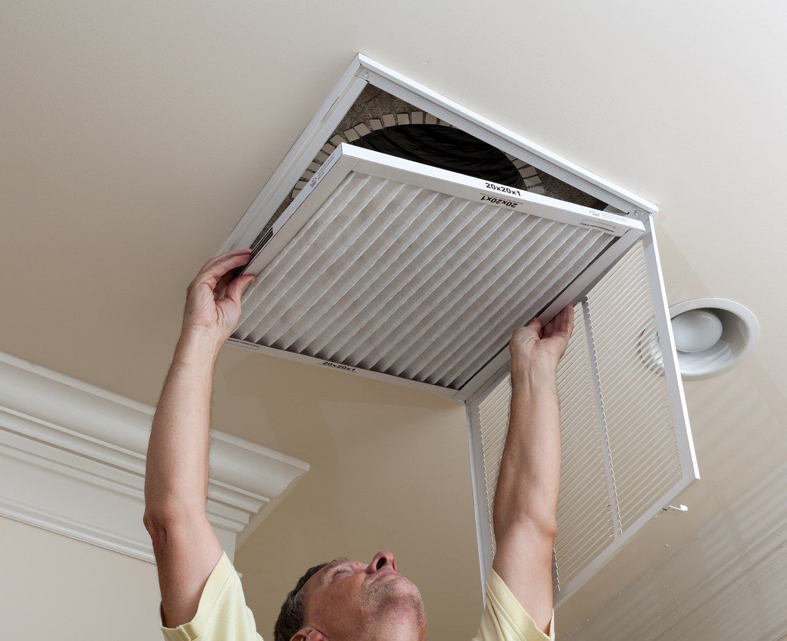 HVAC technician replacing an air filter