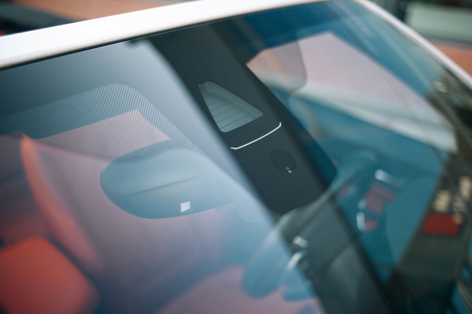 A close up of a car windshield with a camera on it - Seagrove, NC - Seagrove Glass Shop