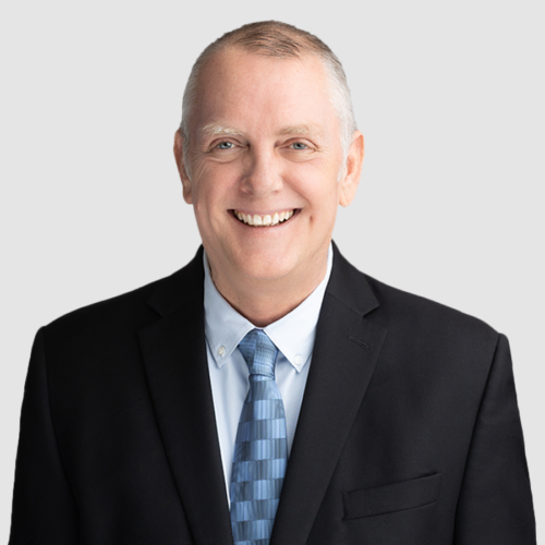 Silhouette of a person with short hair, wearing a suit jacket with a visible collar.