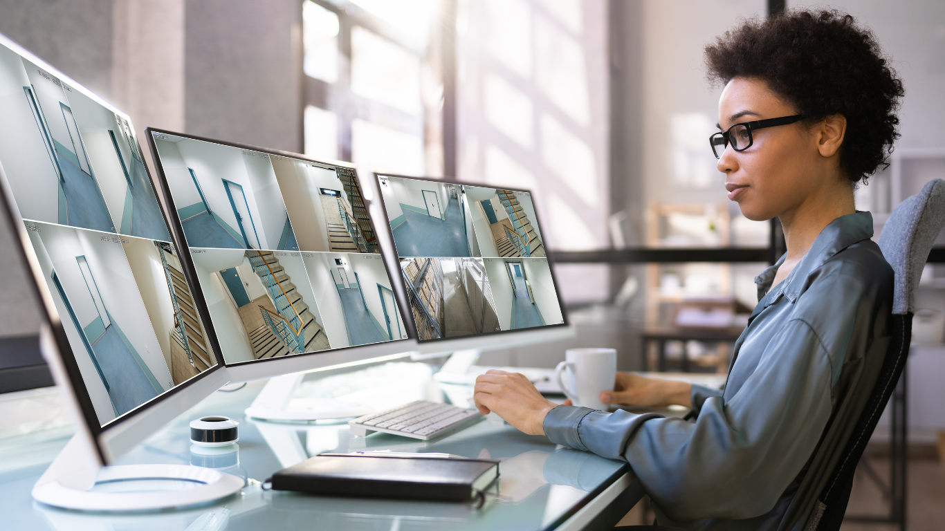 A woman is sitting at a desk working on a computer.