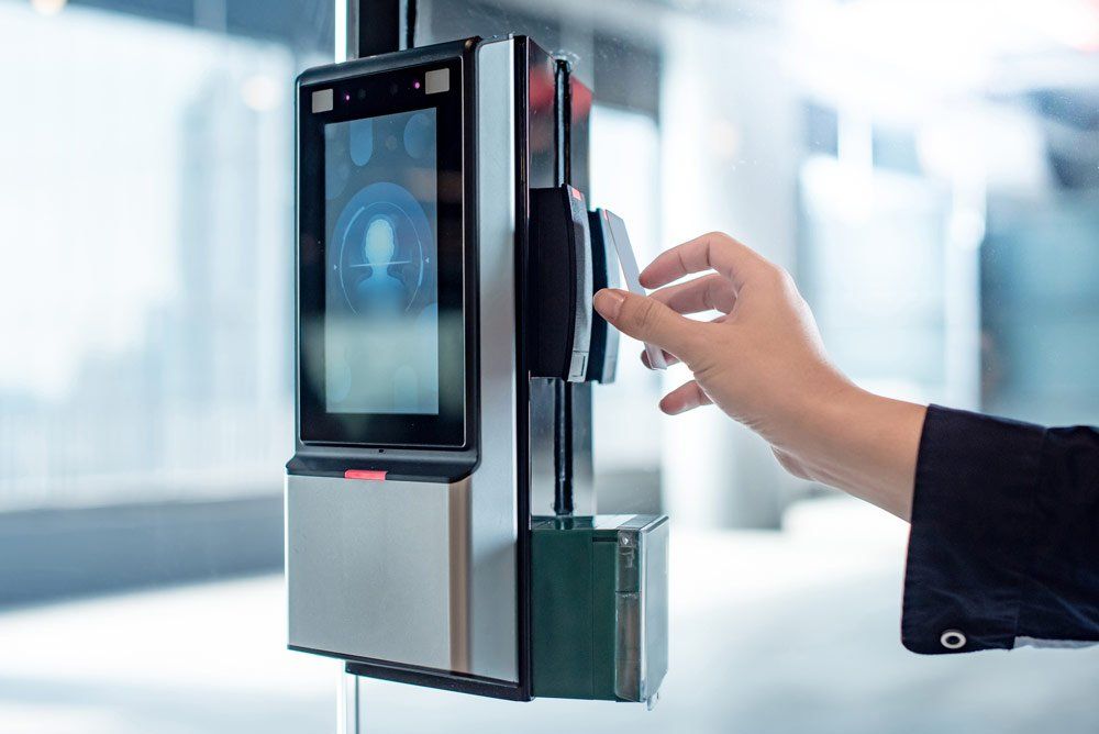 A person is using a smart card to open a door. - access control installation