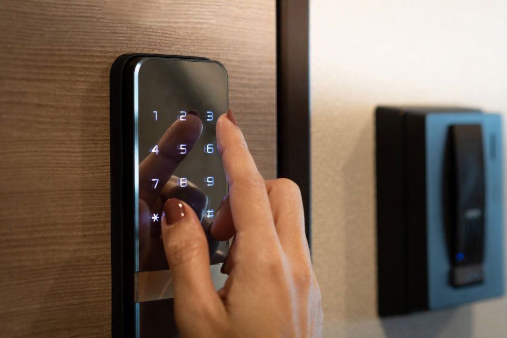 A person is pressing a button on a digital access control system.