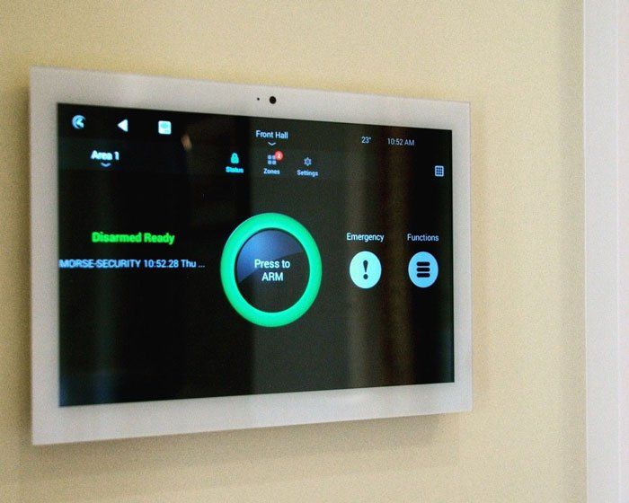 A monitor on a wall that says press to arm