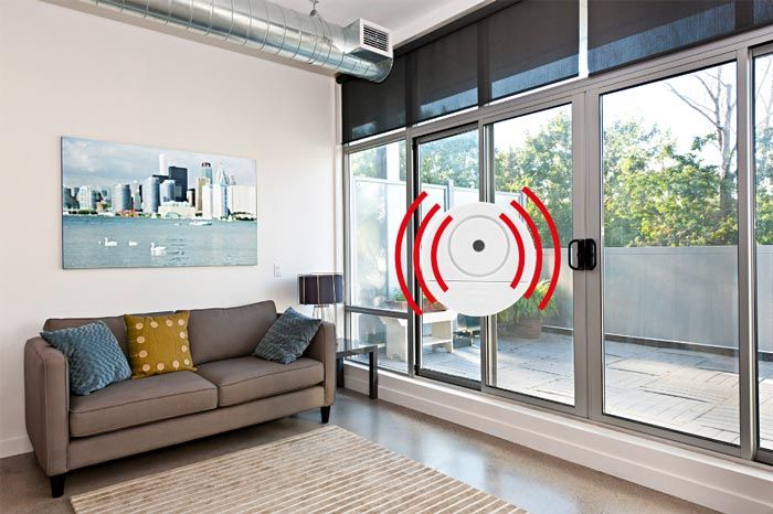 A living room with a couch and a sliding glass door.