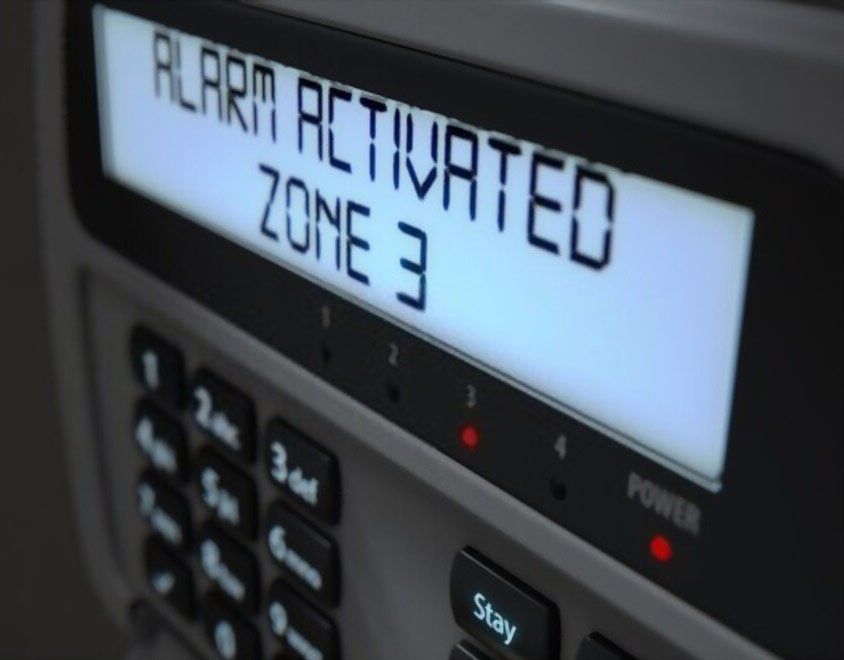 Alarm activated zone 3 is displayed on a keypad