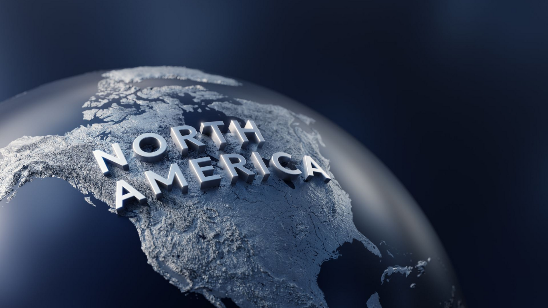 Close-up of a globe highlighting North America in silver text on a dark blue background.
