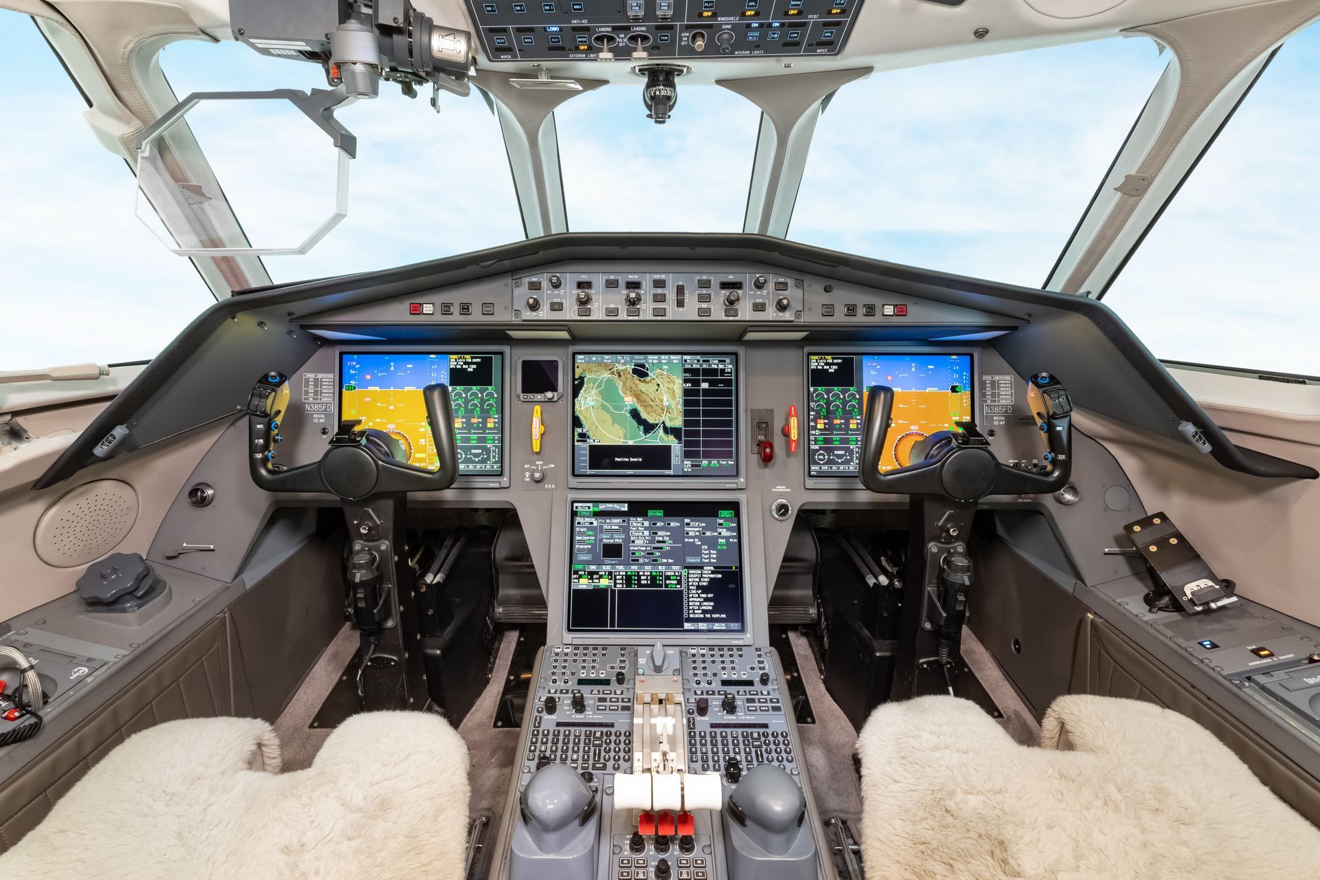 Cockpit view of a Falcon 900EX Easy II private jet, featuring Honeywell Avionics with a Rockwell Collins Heads-Up Display .