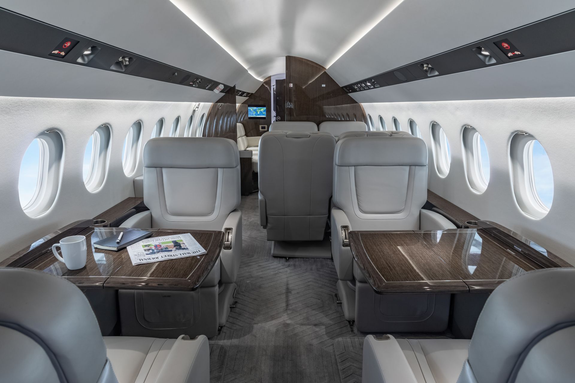 Forward Cabin with Club Seating and Executive Workspace. Main Cabin view of a Falcon 900EX EASy private jet with a fourteen passenger cabin.