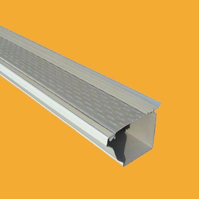 A close up of a gutter on a yellow background.