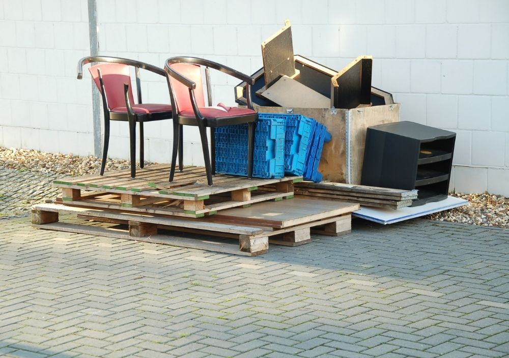 Desk and chairs ready for clearing our from a factory in Cardiff