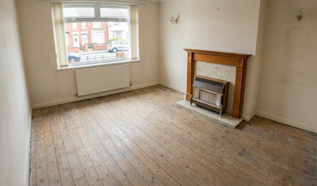 After a bereavement clearance  of highly cluttered living room with newspapers and boxes, which have been completely removed, leaving the room bare.