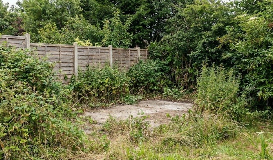 Garden shed cleared from a property in Cardiff. The shed has been completely cleared away, leaving a concrete base. All debris and tools have been removed from the site.