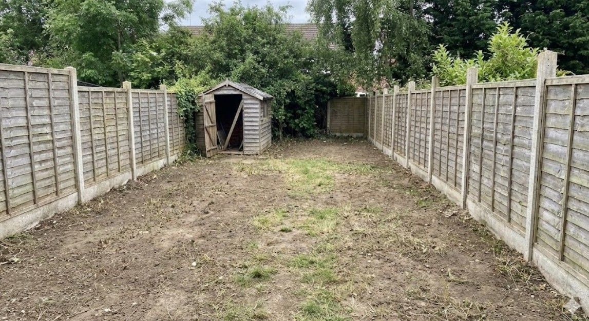 After garden clearance showing the same area cleared, revealing the full size of the garden and its boundaries.