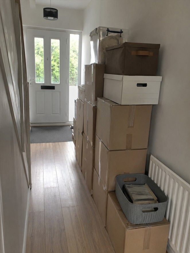 Neatly organised boxes ready for removal during a bereavement clearance in Cardiff