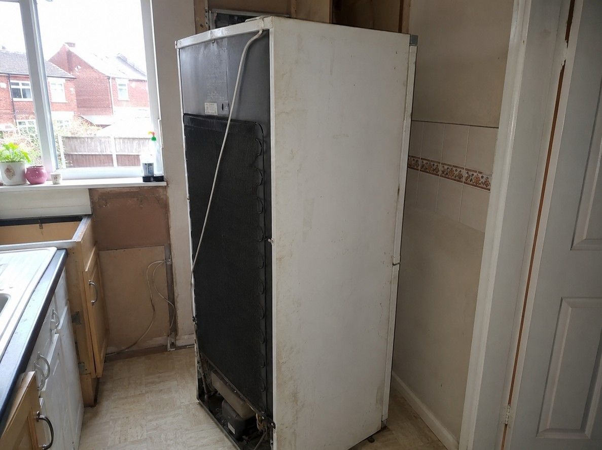 Old fridge freezer pulled out ready for removal by J&Z House Clearance Cardiff