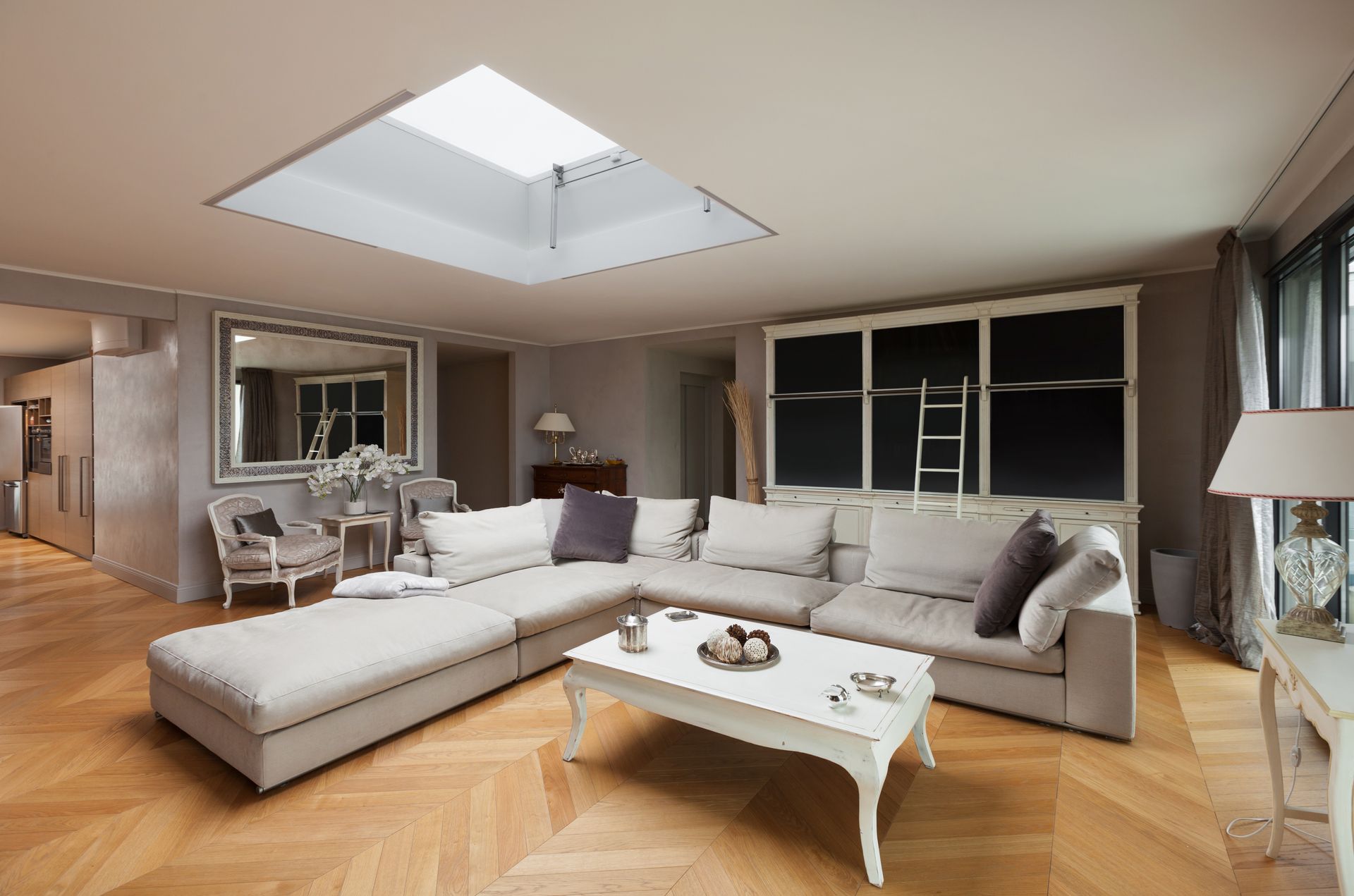 A bright living room featuring a skylight that illuminates the space with natural light.