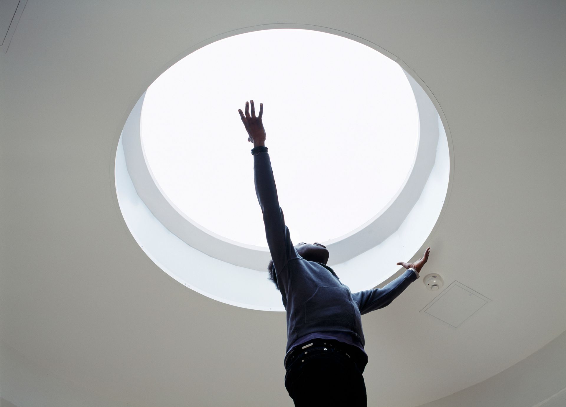 Specialist installing a skylight in the ceiling.