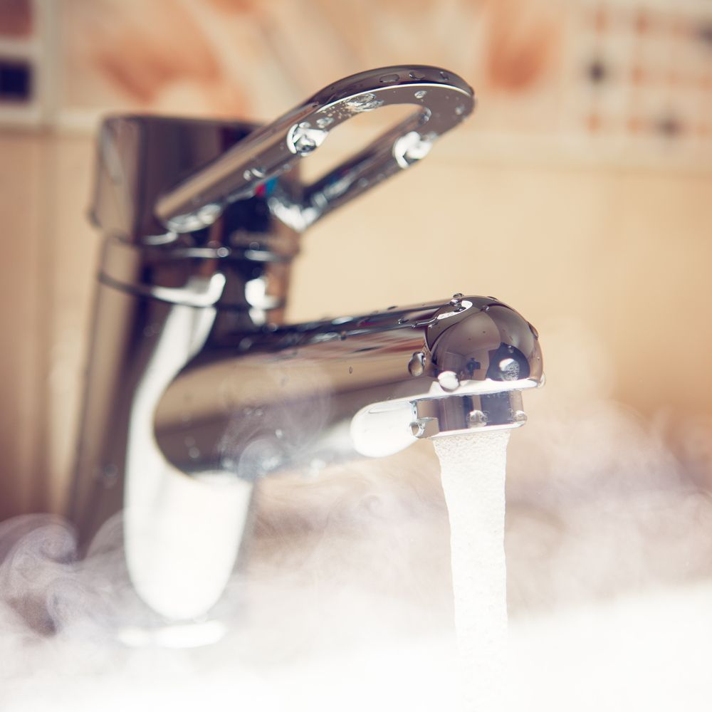 Chrome Faucet With Running, Steaming Water — Illawater Hot Water Services in Wollongong, NSW