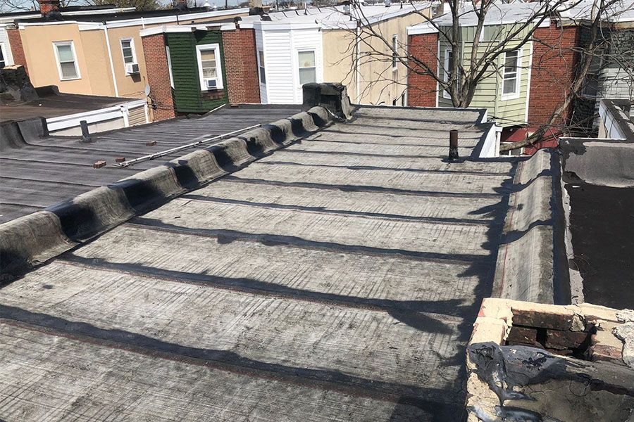 A roof of a building with a chimney on it.