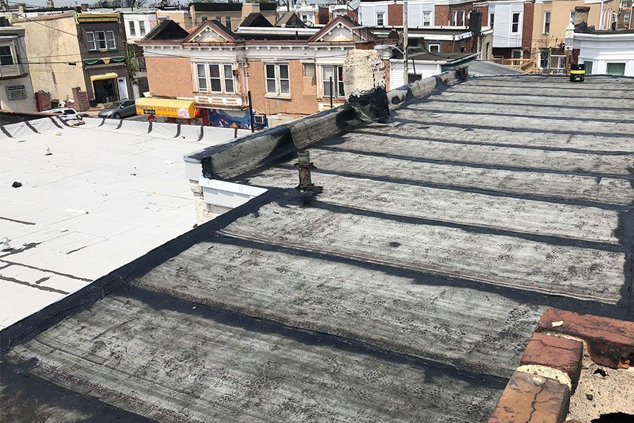 A roof of a building with a brick chimney on it.