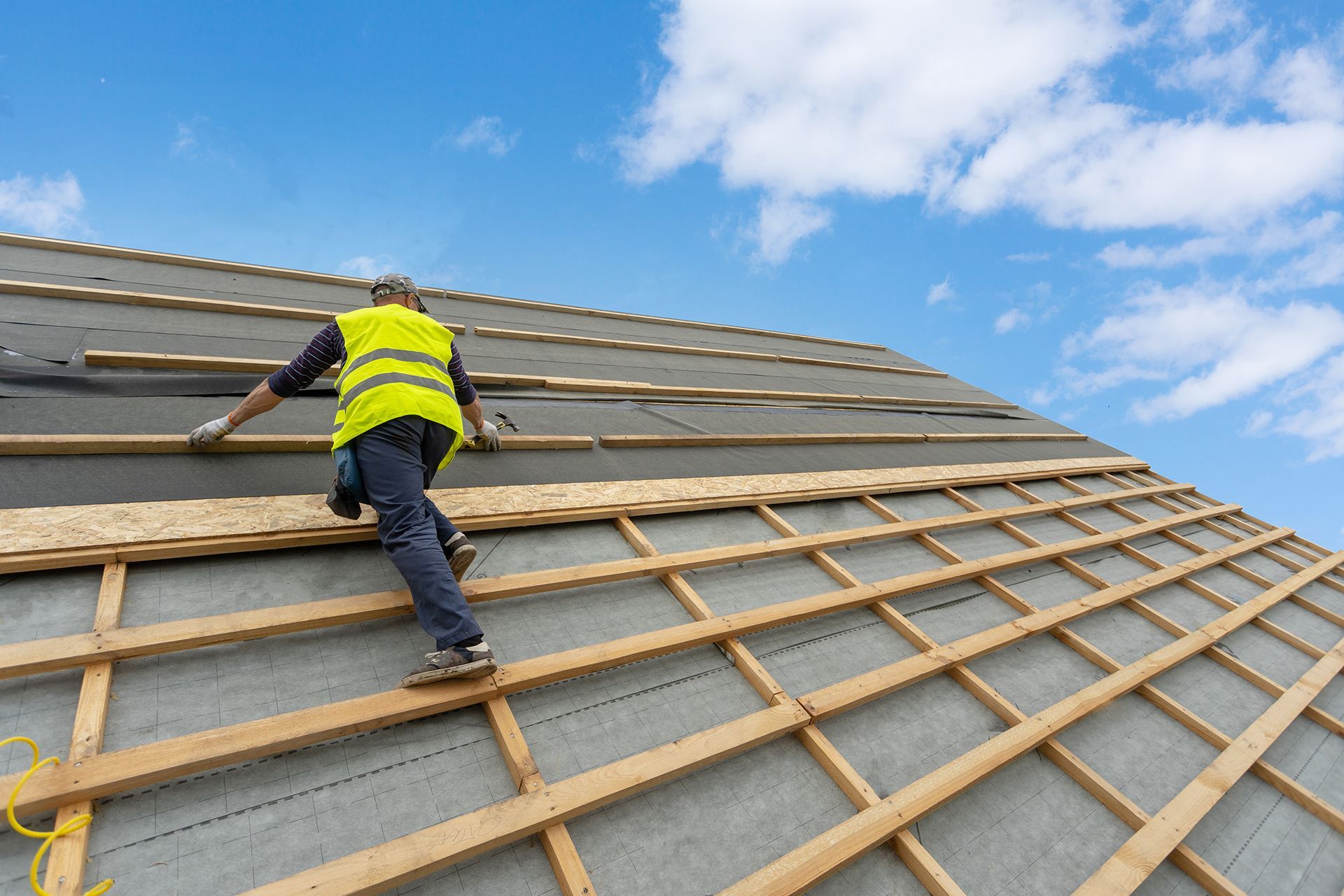 A man is standing on top of a roof.