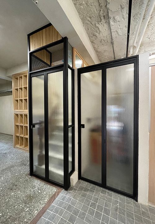 A room with a staircase and a glass door.