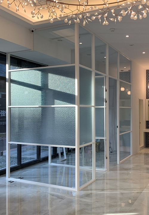 A room with a lot of windows and a chandelier on the ceiling.