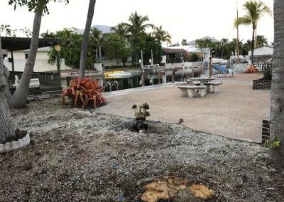 A picnic area with a stump in the middle of it