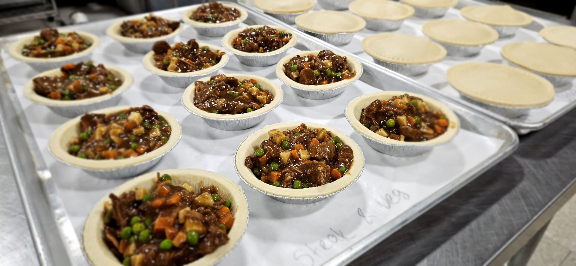 Hearty Steak Pot Pie - Tender beef chunks, carrots, green peas, and potatoes simmered in a rich, aromatic beef gravy with a hint of rosemary—all tucked into a flaky, golden crust. Comfort food at its finest, proudly Made in Canada!