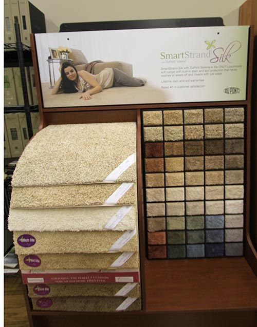 A woman is lying on a couch in front of a sign