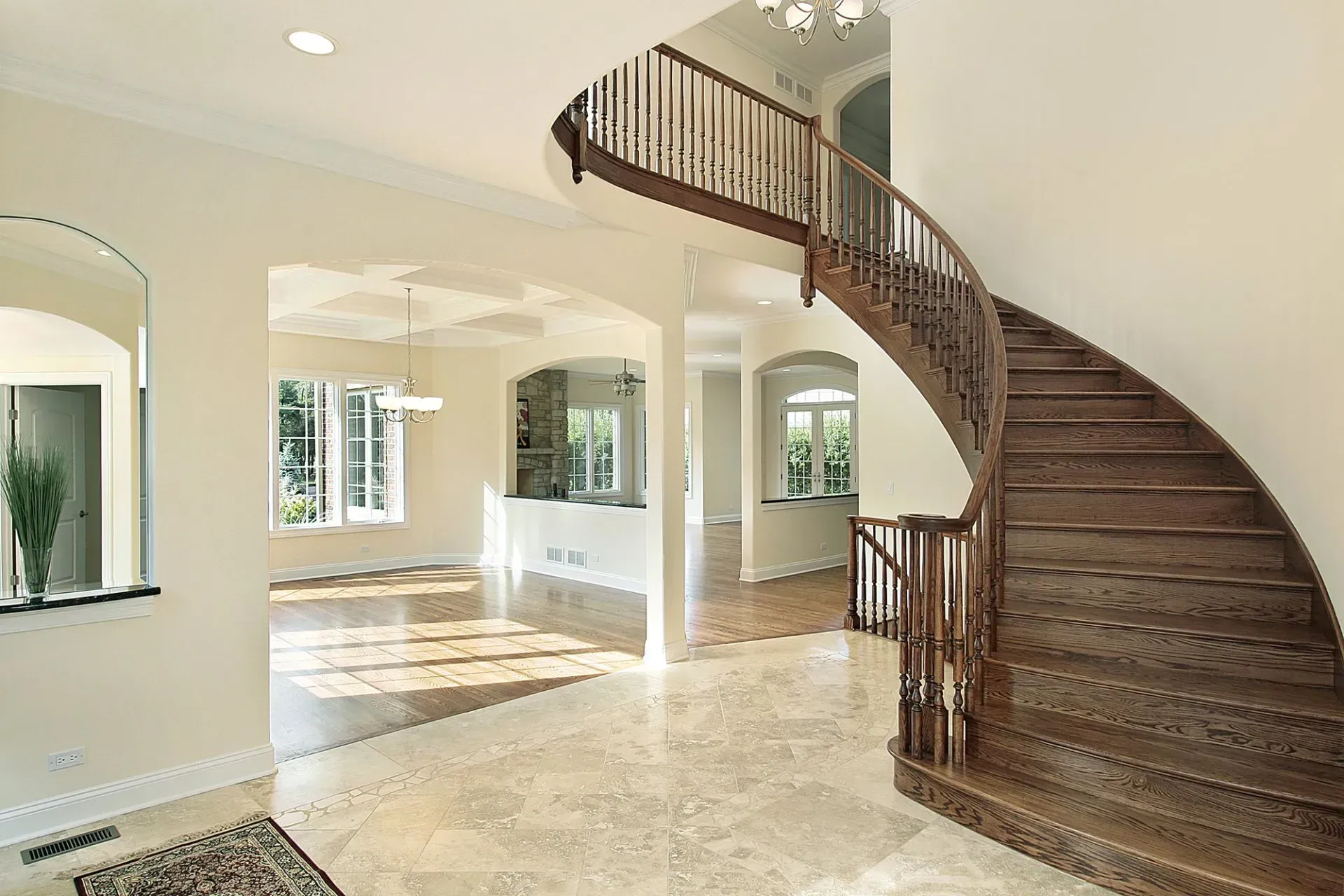 A large empty house with a wooden spiral staircase