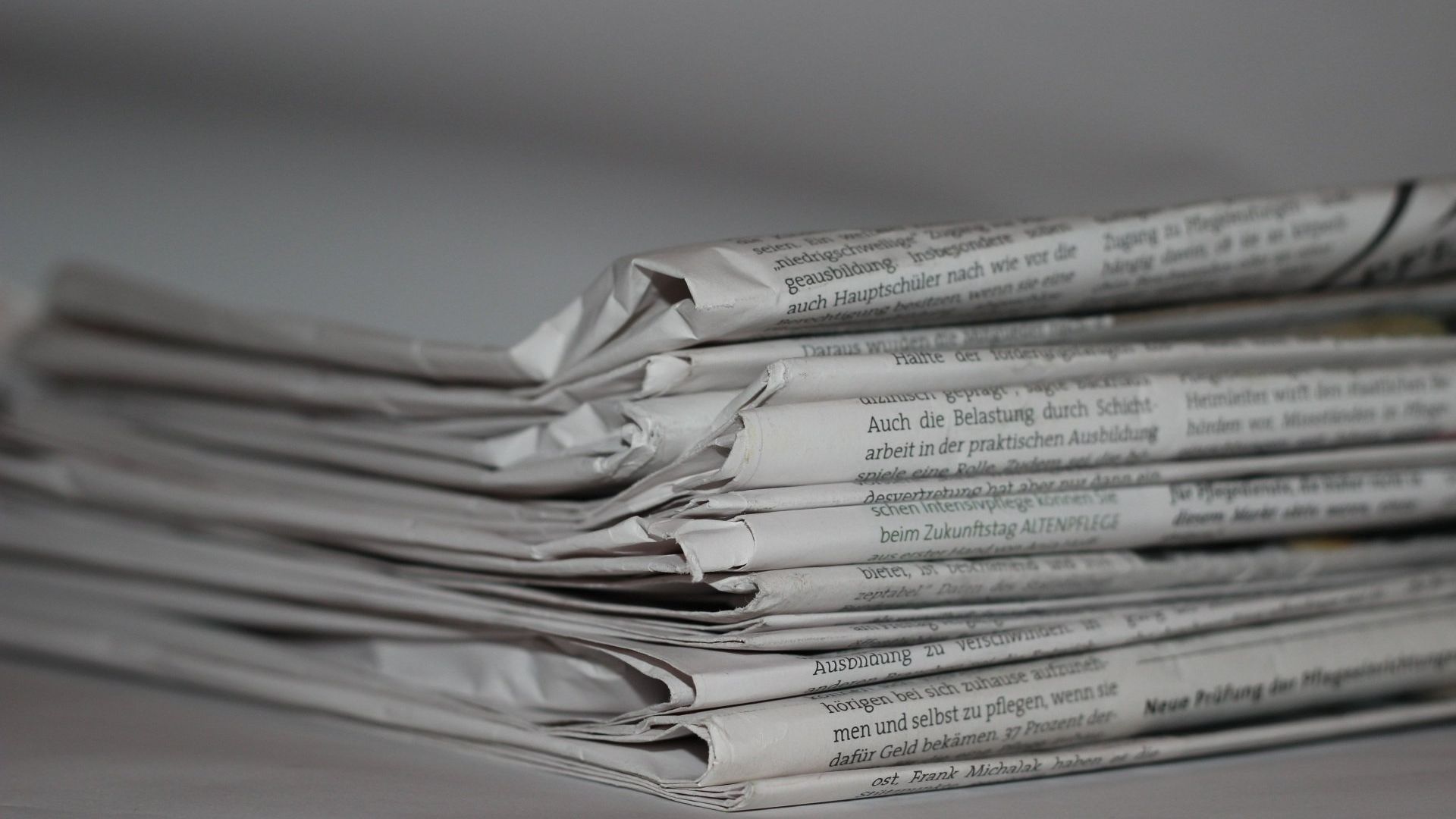 Stack of Newspapers with Funeral Notice