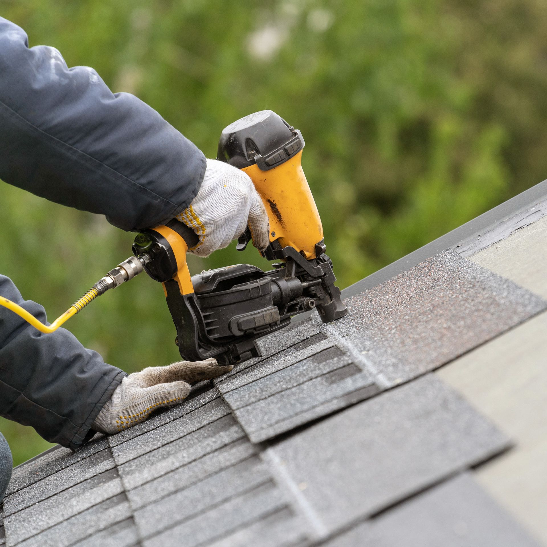 A man installing roof tiles