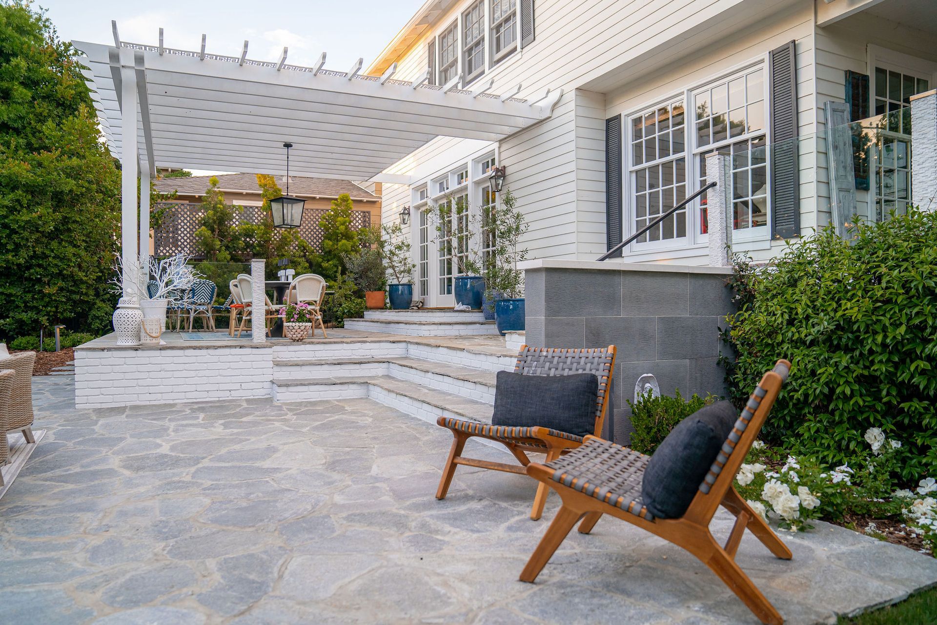 Stone steps ascending between stacked stone walls, surrounded by greenery.