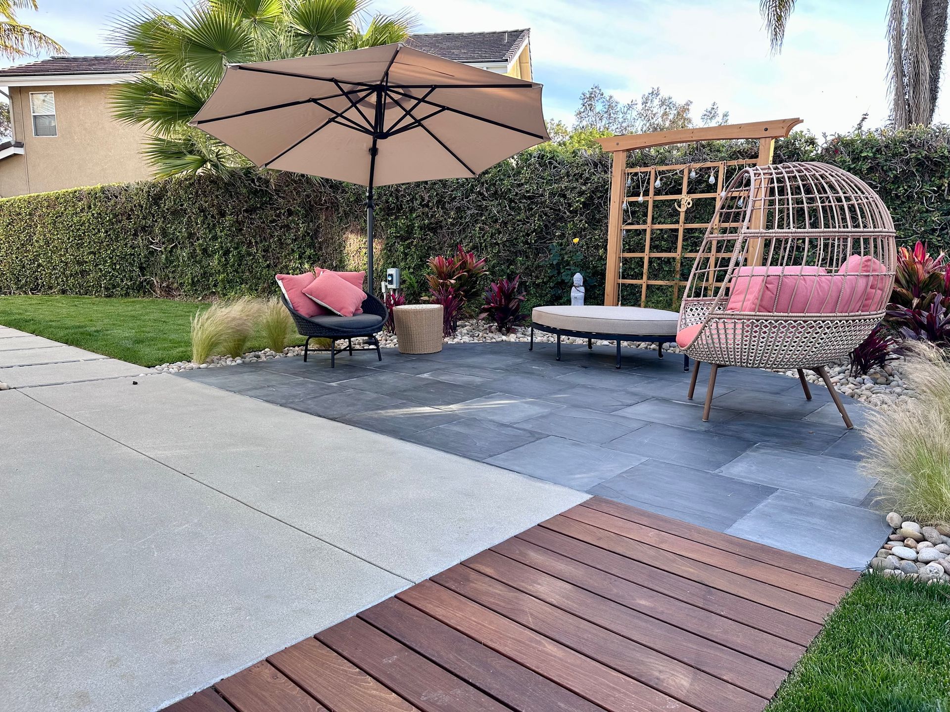 A bathroom with a sink and a walk in shower with a glass door.