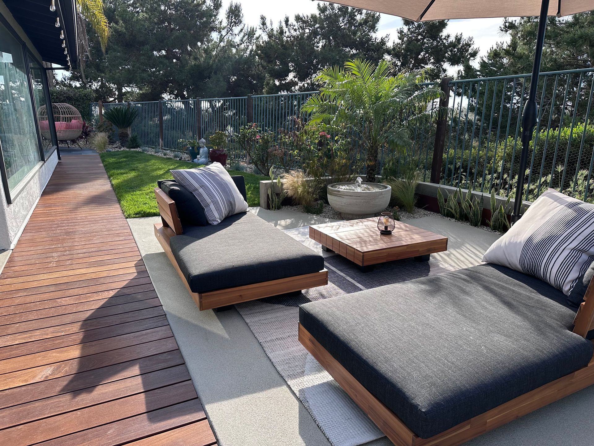 A bathroom with a sink and a walk in shower with a glass door.