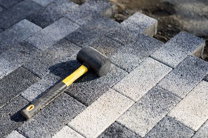 A kitchen with white cabinets, wooden floors, and a large island.