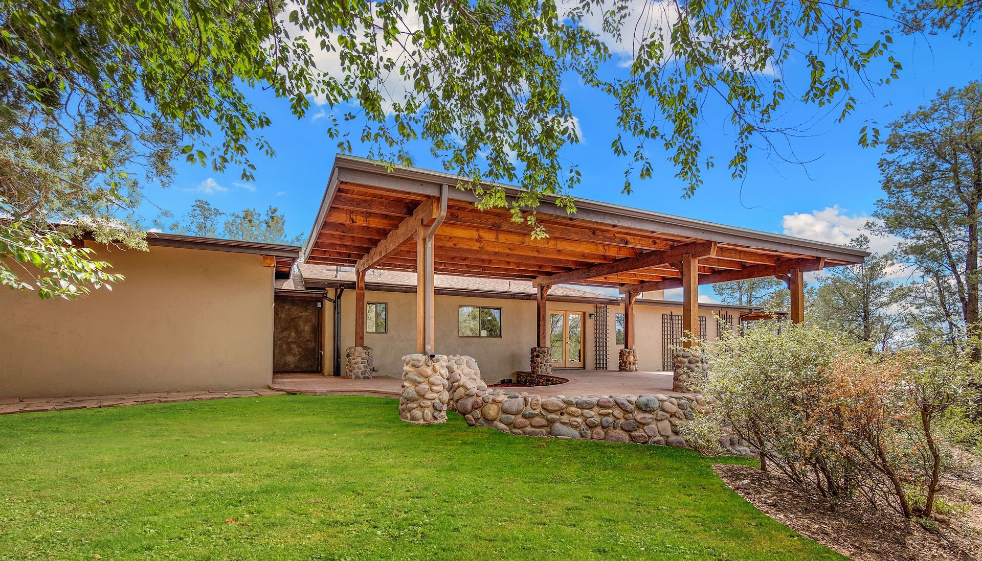 There is a bowl of fruit on the counter in the kitchen.