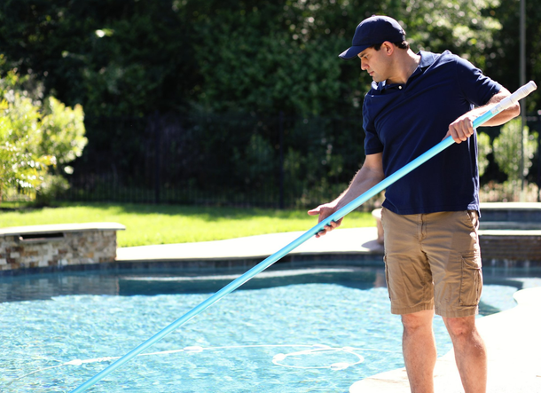 Cleaning Service Man in Swimming Pool - Holmdel, NJ - Suburban Services Inc