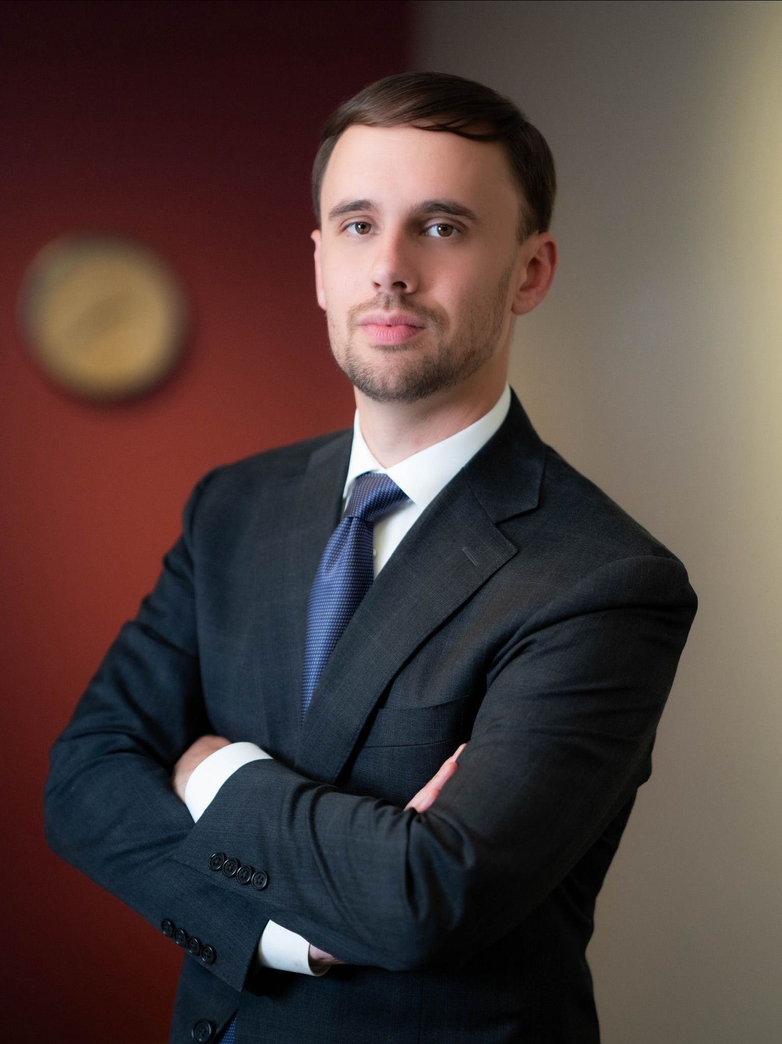 A man in a suit and tie is smiling for the camera.
