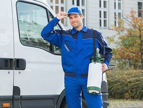 Pest Control — Exterminator With Blue Uniform And Cap Carrying Tools In Melbourne, Fl